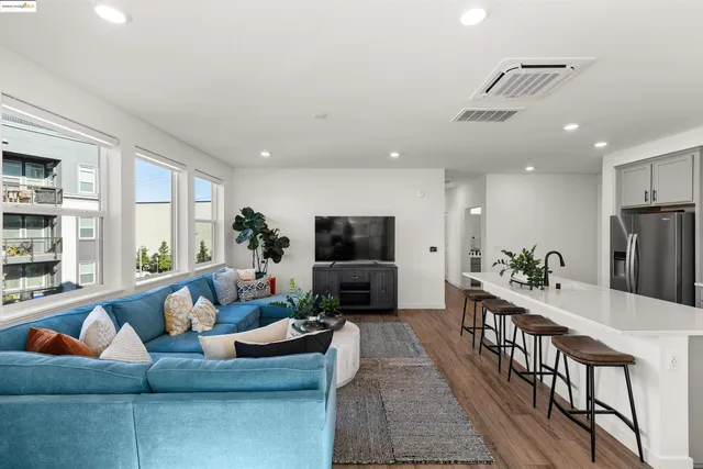 a living room with furniture wooden floor and a flat screen tv