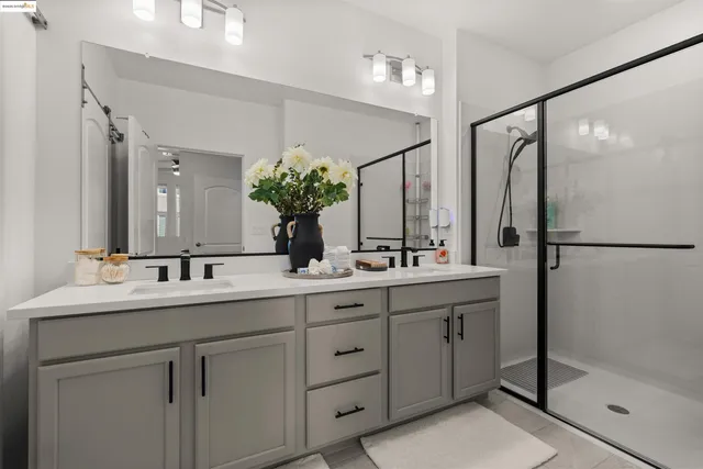 a bathroom with a double vanity sink and a mirror