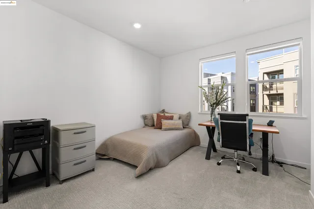 a bedroom with a bed a table and a chair