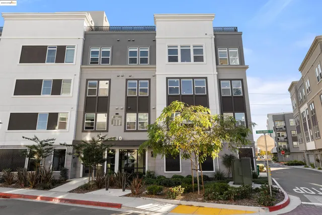 a view of a brick house with a large windows and plants