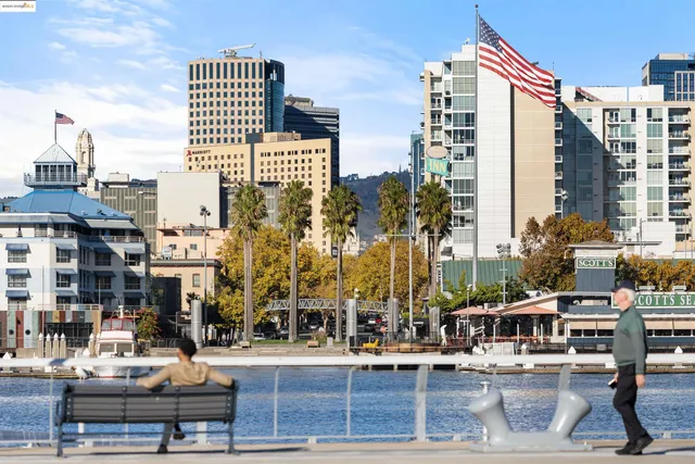 a view of roof deck with a barbeque and wooden stairs