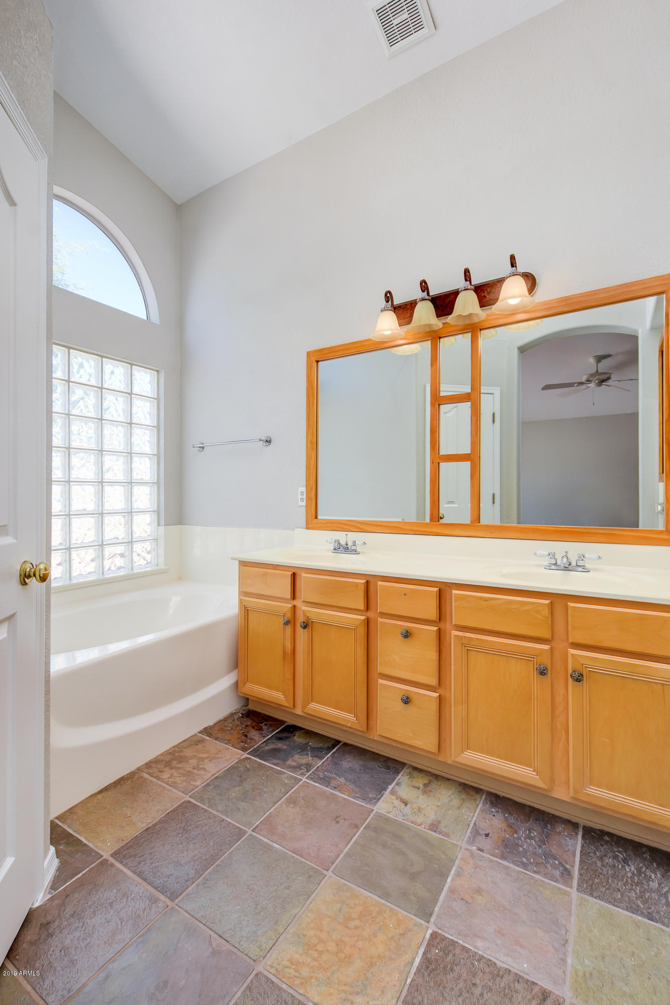 4404 East Rowel Road Phoenix, AZ 85050 - Photo 12 of 15 a spacious bathroom with a tub sink and mirror