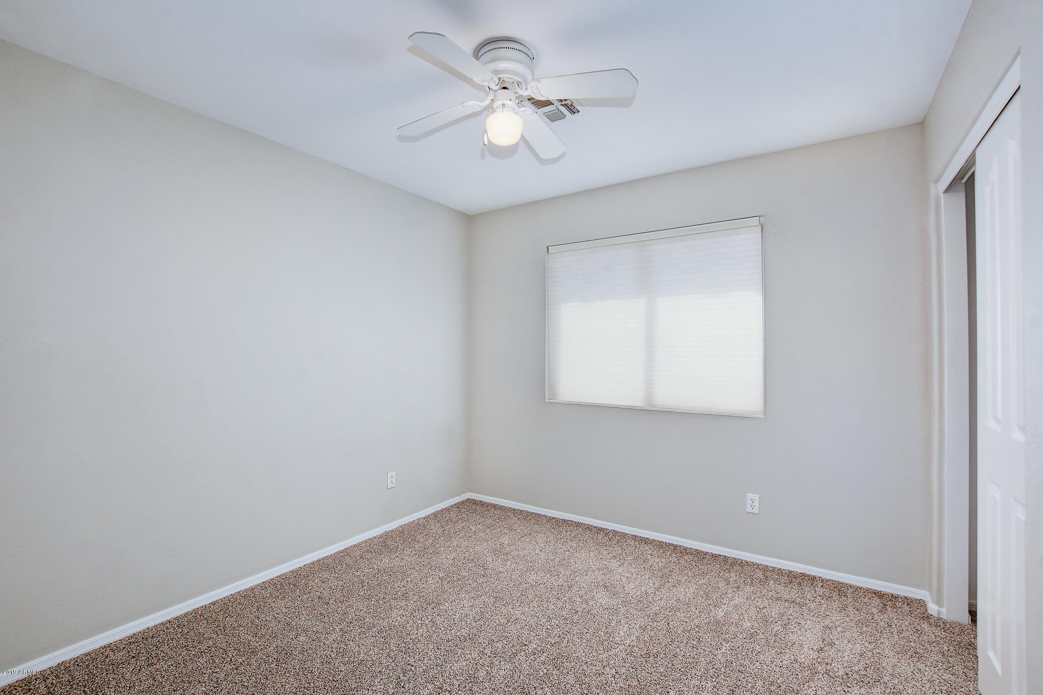 4404 East Rowel Road Phoenix, AZ 85050 - Photo 14 of 15 an empty room with a window and a ceiling fan