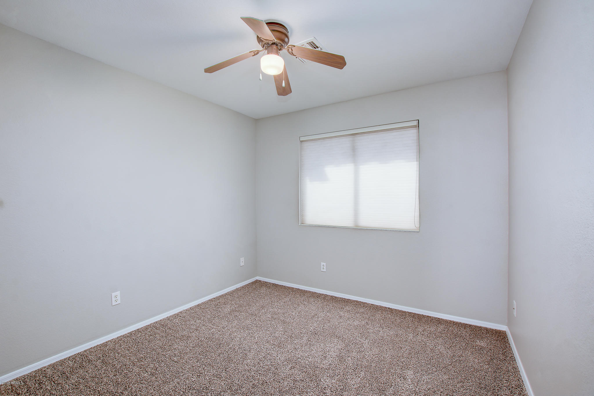 4404 East Rowel Road Phoenix, AZ 85050 - Photo 15 of 15 an empty room with a window and a fan