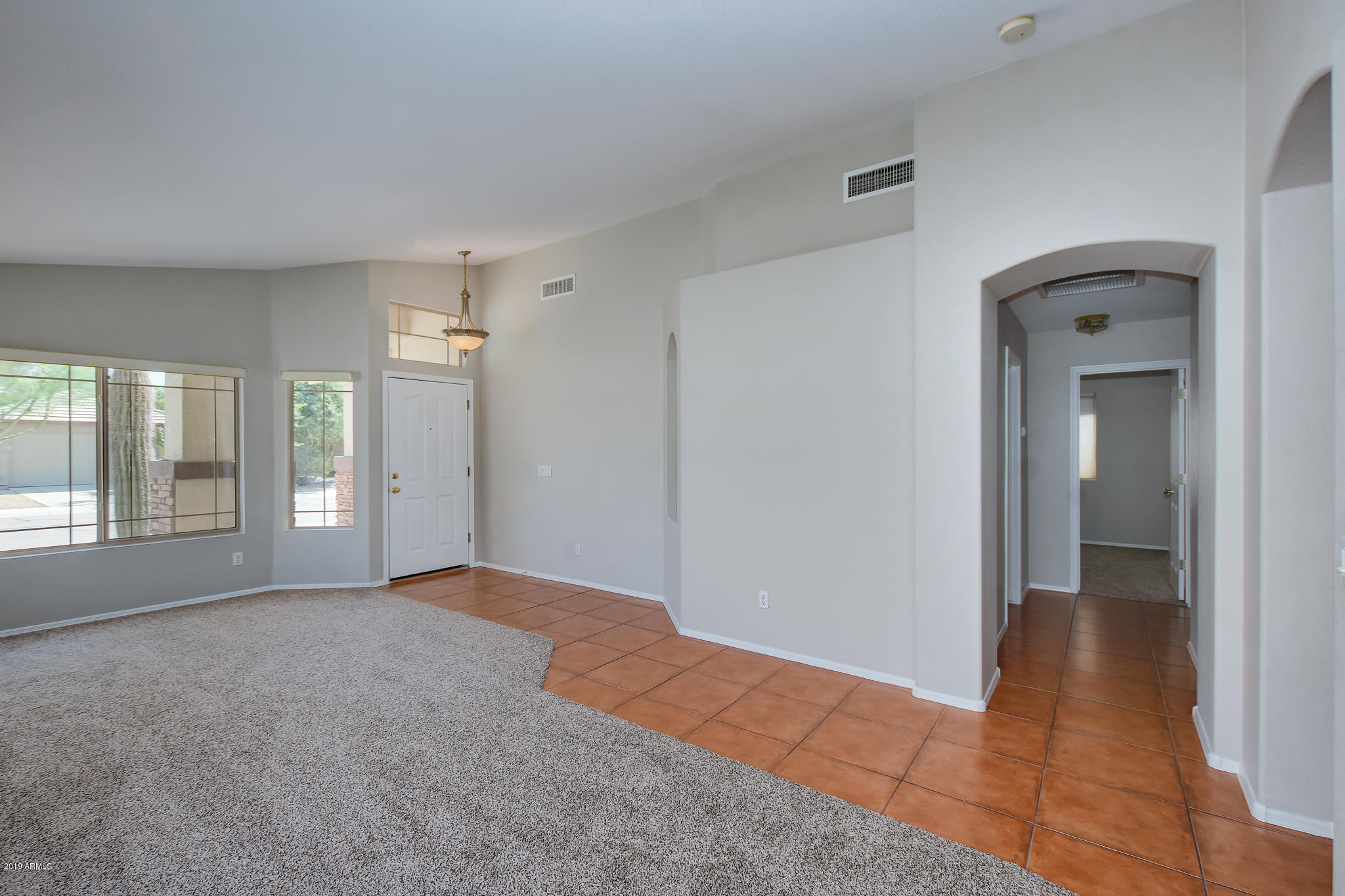 4404 East Rowel Road Phoenix, AZ 85050 - Photo 3 of 15 a view of empty room with window and wooden floor