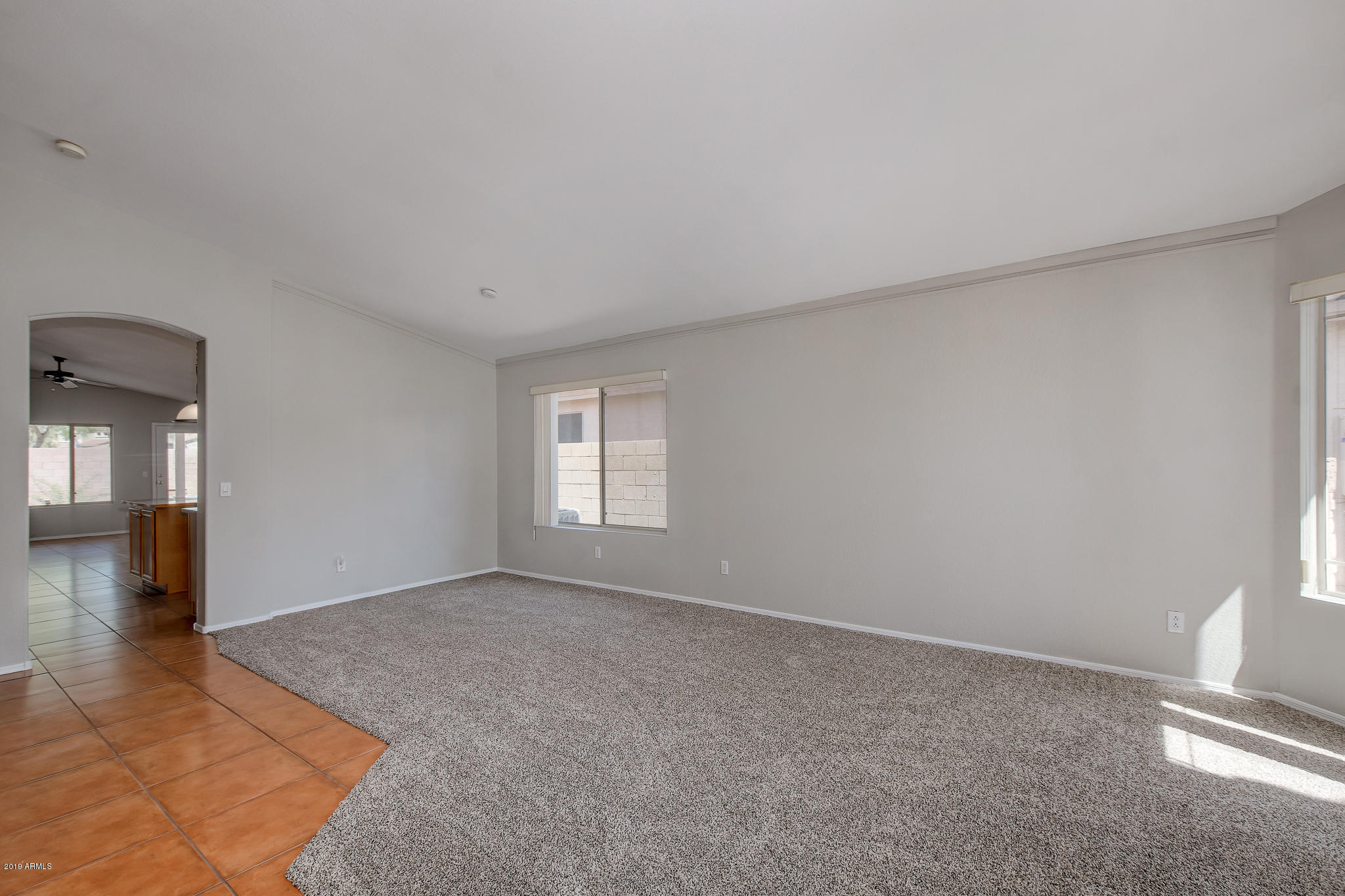 4404 East Rowel Road Phoenix, AZ 85050 - Photo 4 of 15 a view of an empty room with window and wooden floor