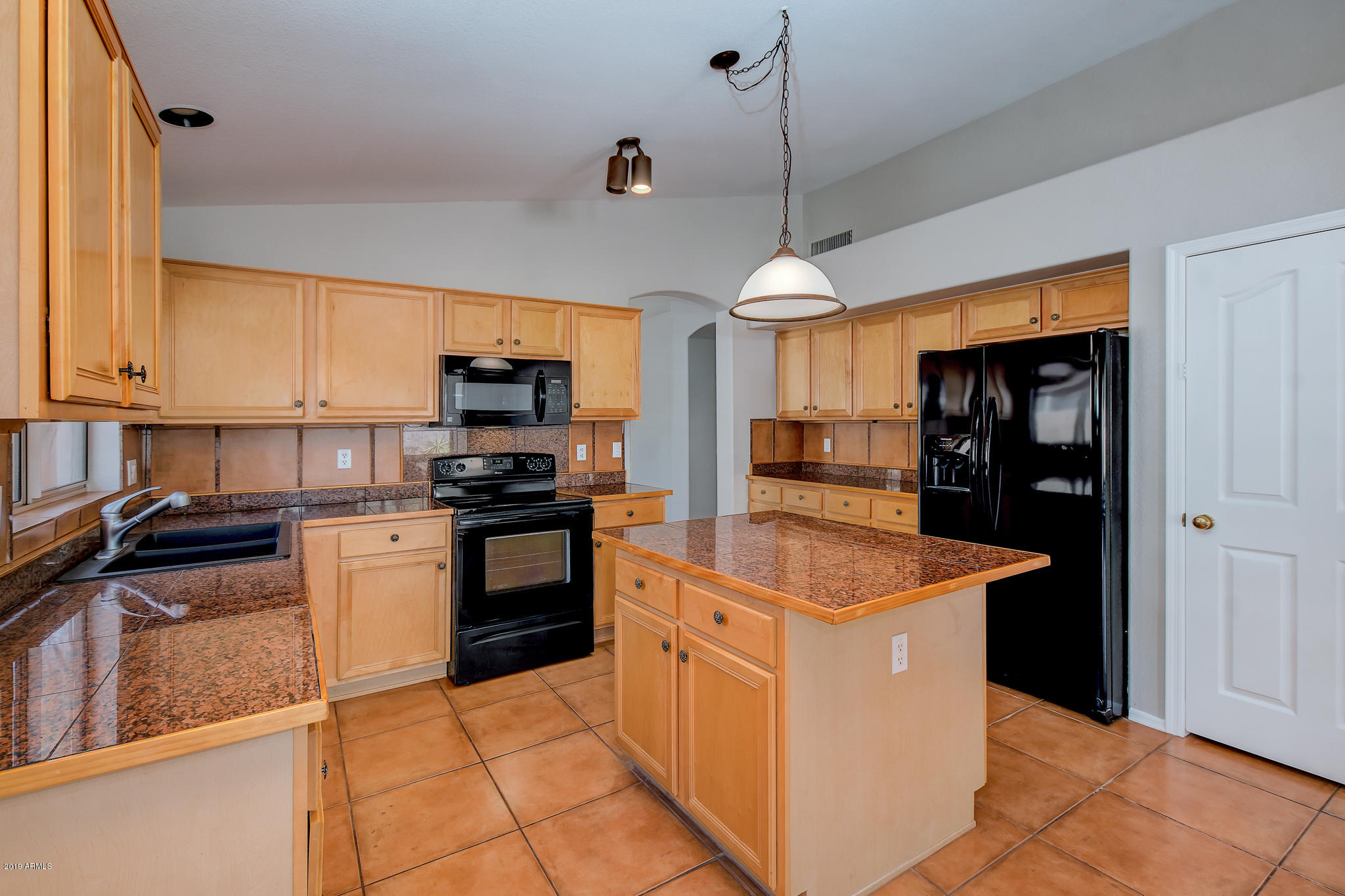 4404 East Rowel Road Phoenix, AZ 85050 - Photo 5 of 15 a kitchen with stainless steel appliances granite countertop a stove and a refrigerator