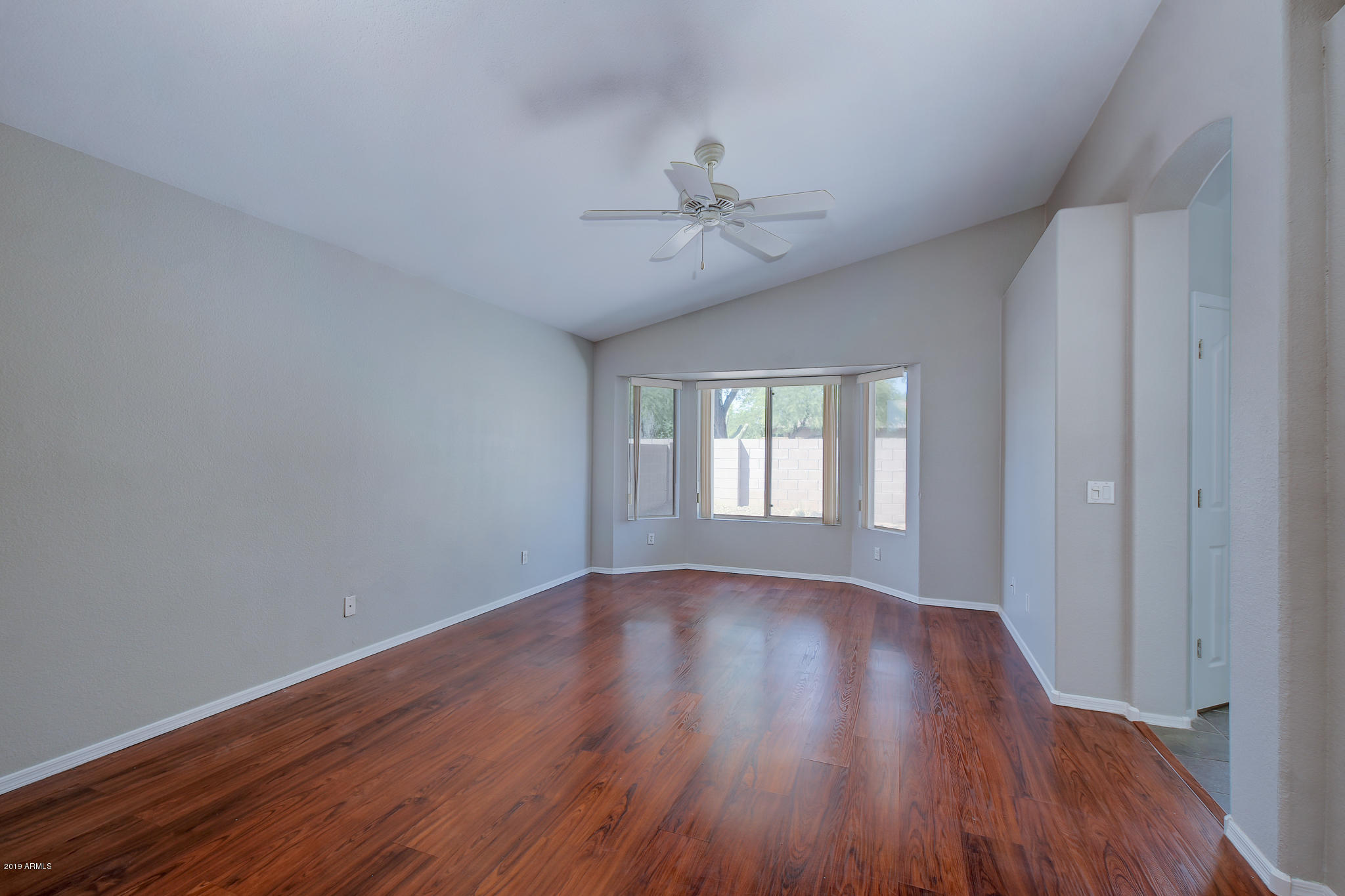 4404 East Rowel Road Phoenix, AZ 85050 - Photo 9 of 15 a view of an empty room with wooden floor and a window