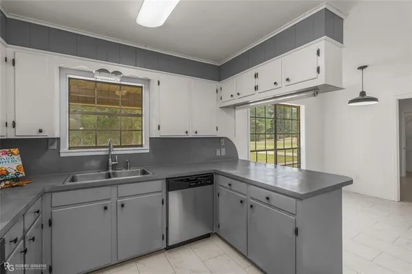 a kitchen with granite countertop white cabinets white appliances and a sink