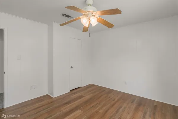 a view of a room with wooden floor