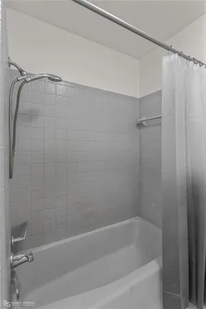 a bathroom with a shower and a bath tub