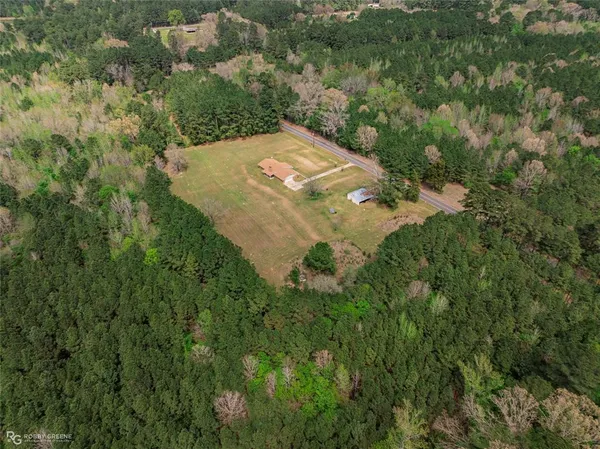 an aerial view of a house with a yard