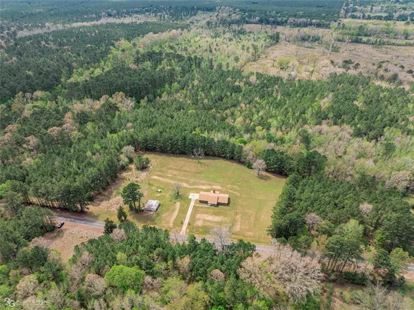 an aerial view of a house with a yard