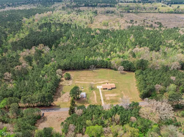 an aerial view of a house with a yard