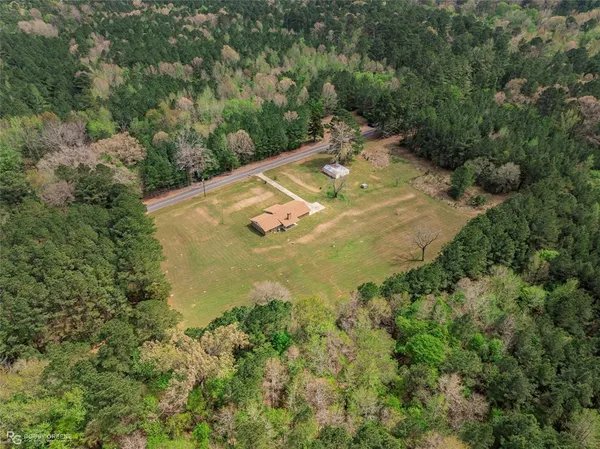 an aerial view of a house with a yard