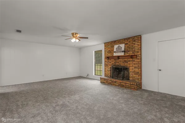 a view of an empty room with a fireplace