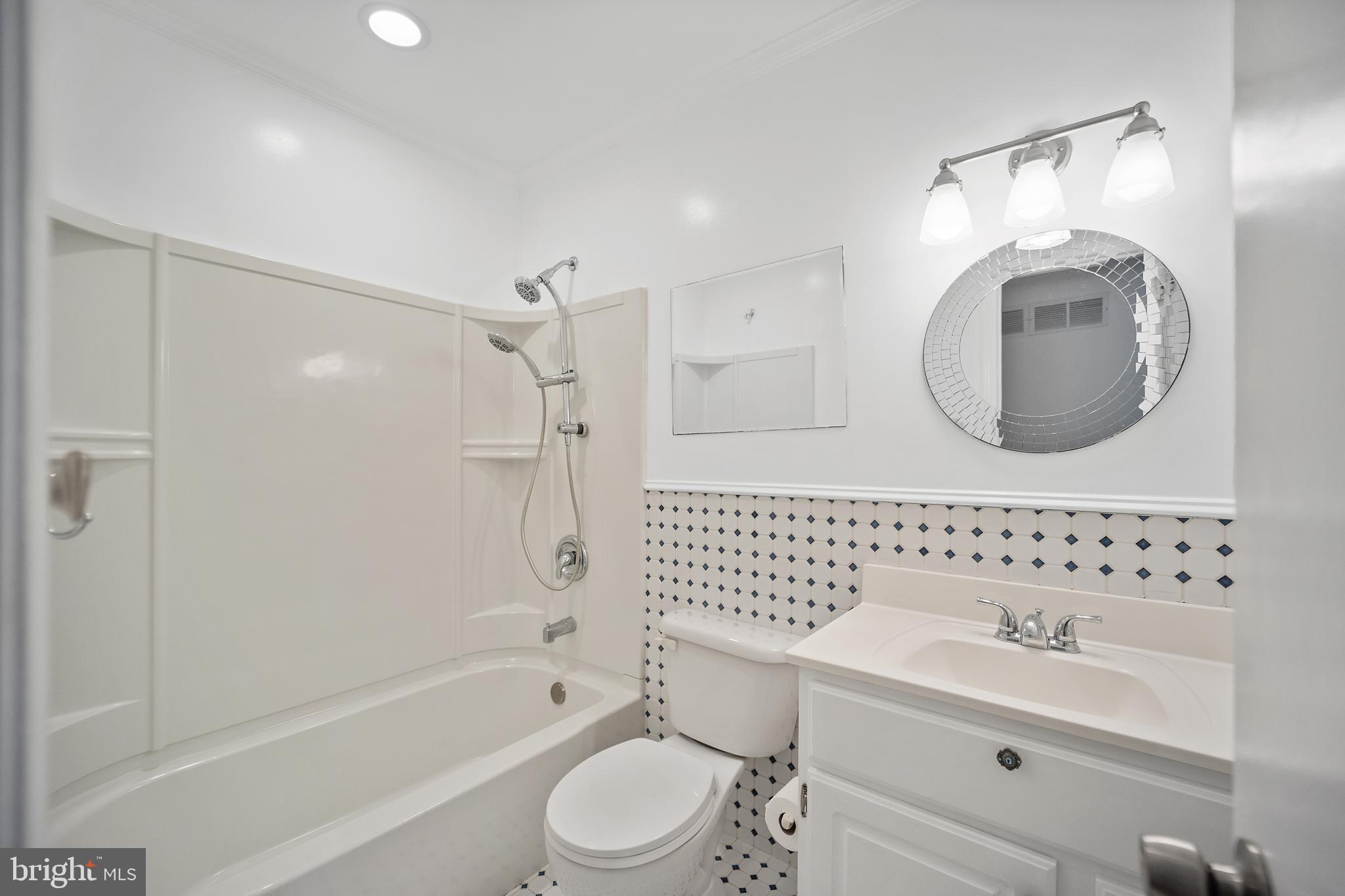 705 Halstead Road Wilmington, DE 19803 - Photo 16 of 34 a bathroom with a toilet sink vanity tub and shower