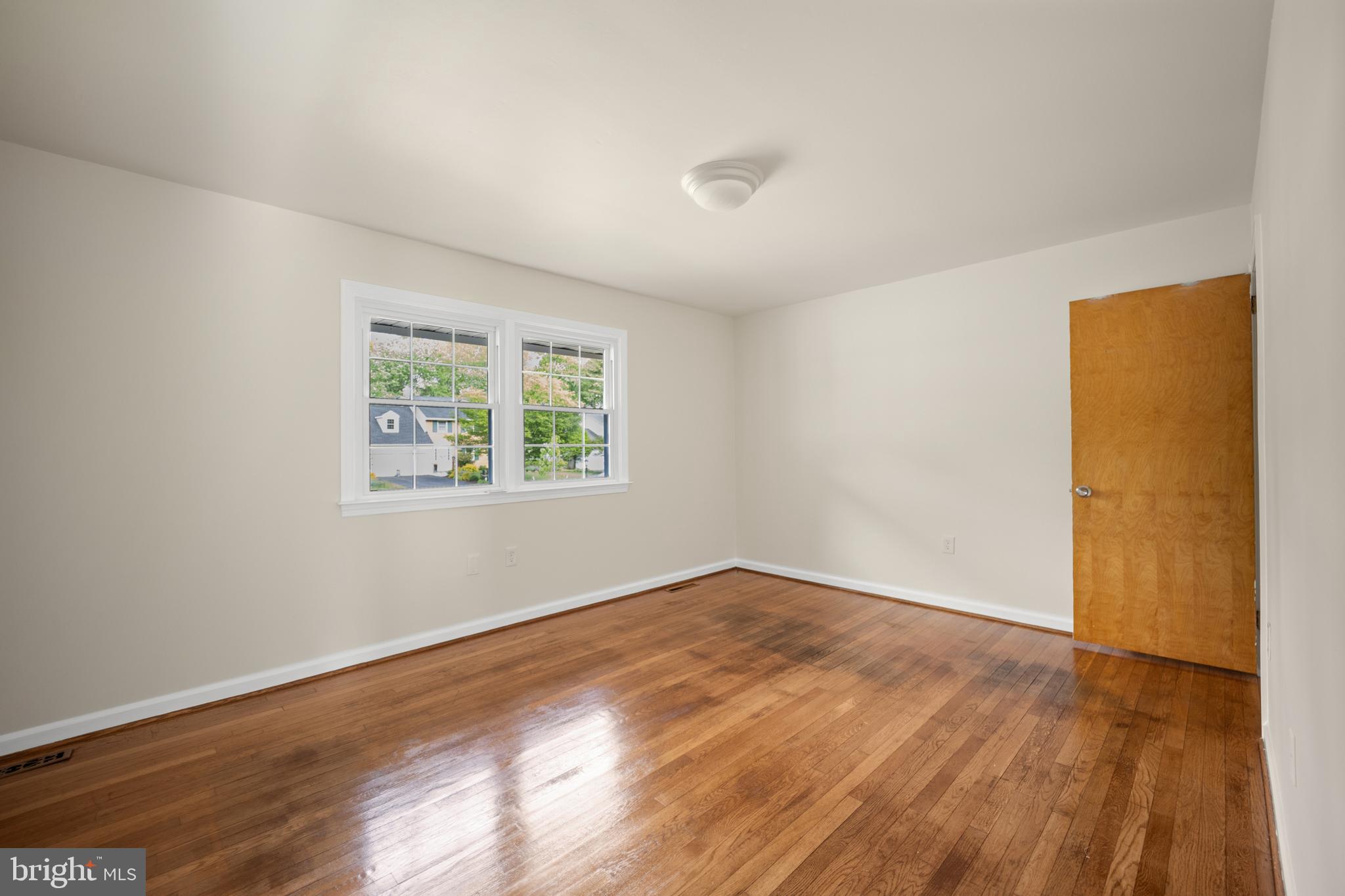 705 Halstead Road Wilmington, DE 19803 - Photo 17 of 34 an empty room with wooden floor and windows