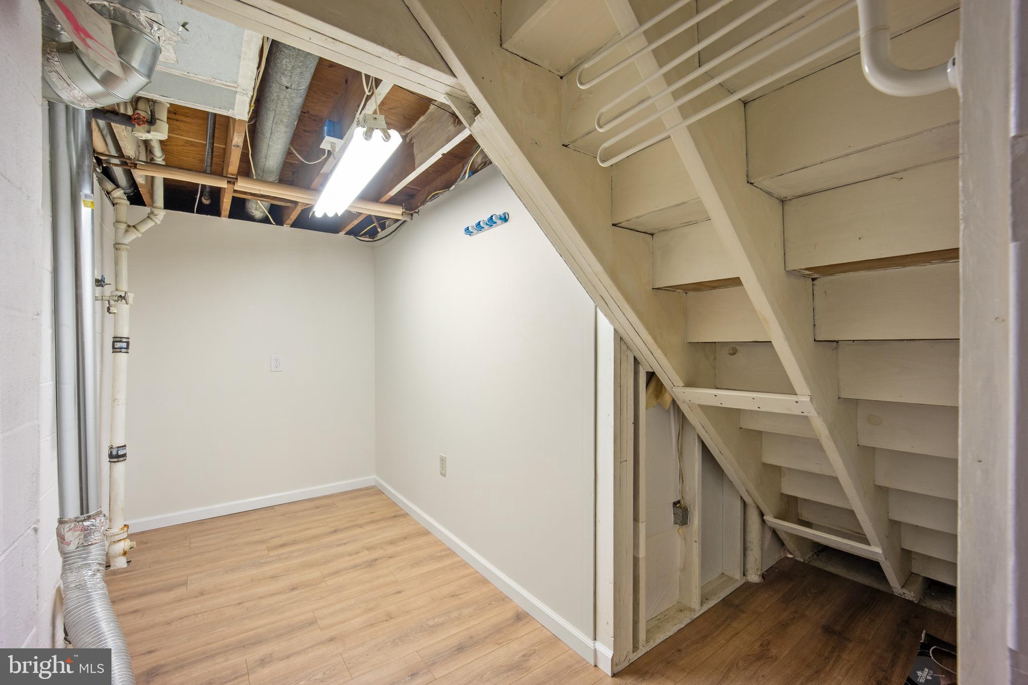 705 Halstead Road Wilmington, DE 19803 - Photo 26 of 34 a view of an empty room with wooden floor and staircase