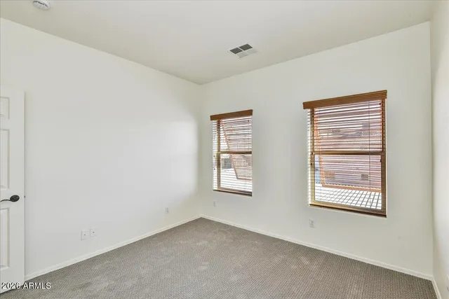 a view of an empty room with windows