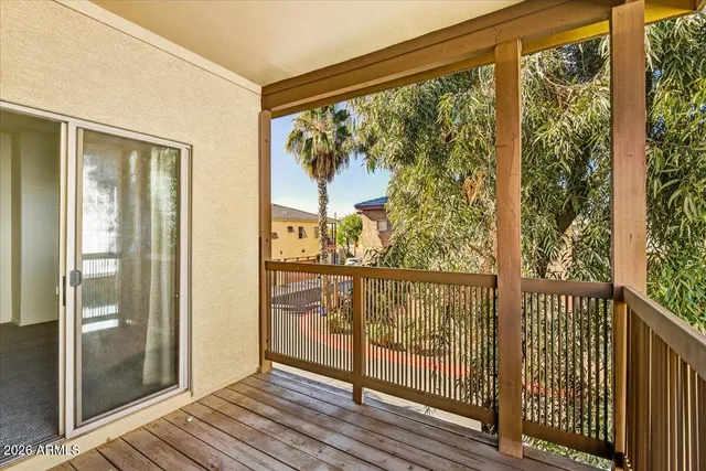 a view of a balcony with wooden floor
