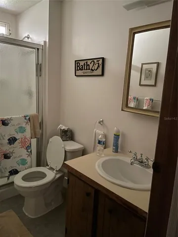 a bathroom with a sink mirror a toilet and a mirror