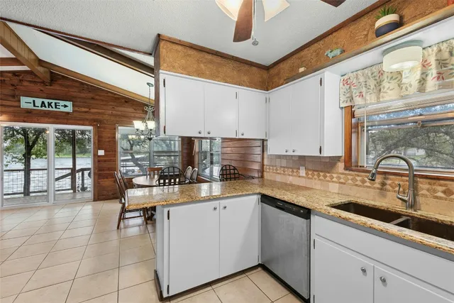 a kitchen with a sink cabinets and window