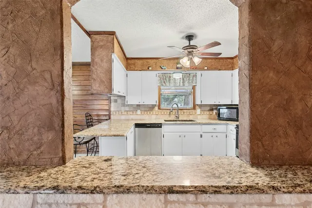 a kitchen with a sink cabinets and appliances