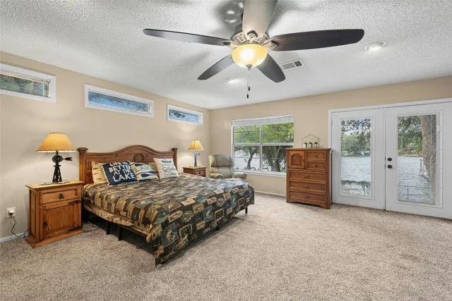 a bedroom with a bed and ceiling fan