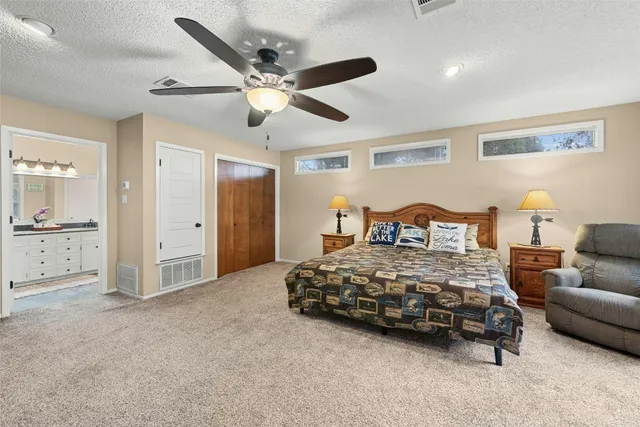 a bedroom with a bed and ceiling fan