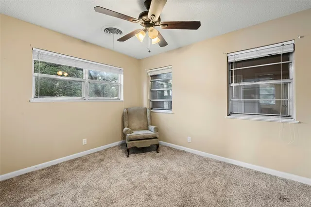 a view of workspace with window and ceiling fan