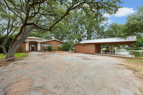 a backyard of a house with yard and tree