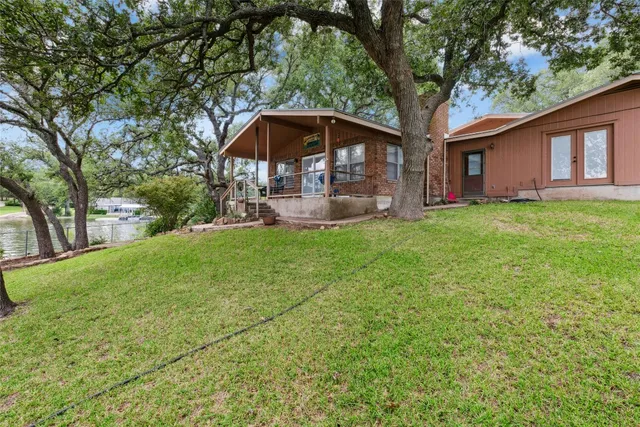 a view of a house with a yard and sitting area