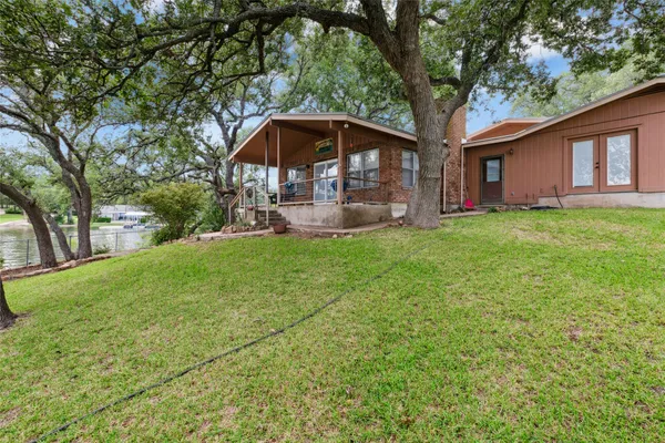 a view of a house with a yard and sitting area