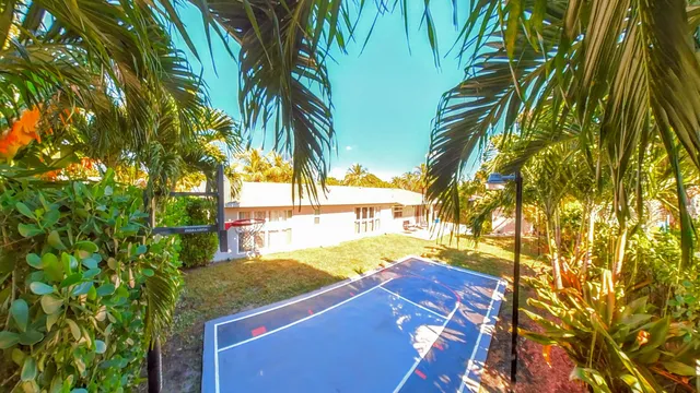 a living room with furniture chandelier and a view of kitchen