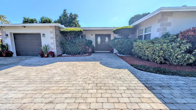 a living room with furniture a flat screen tv and a window