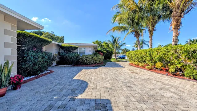 a kitchen with a dining table chairs refrigerator and microwave