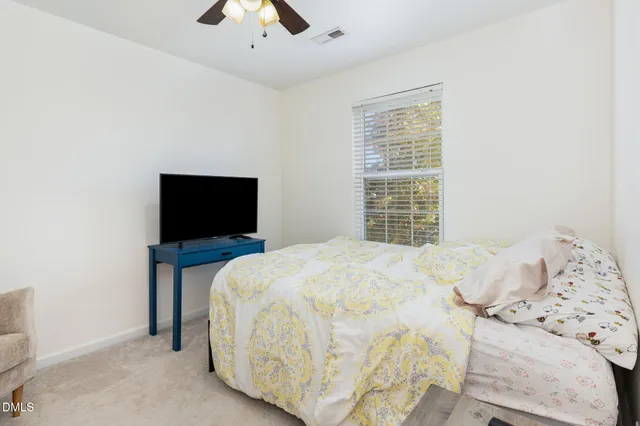 a large white bed in a white room