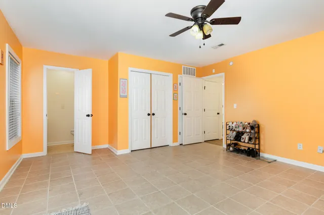 a view of a livingroom with a ceiling fan and window