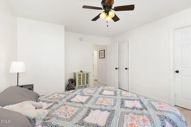 a bed sitting in a bedroom next to a window