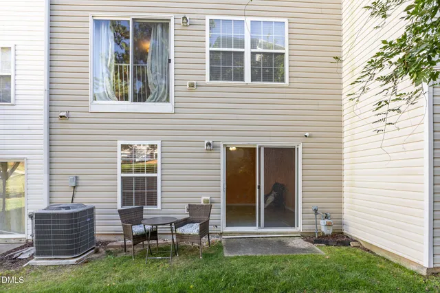 a view of a house with a yard and sitting space