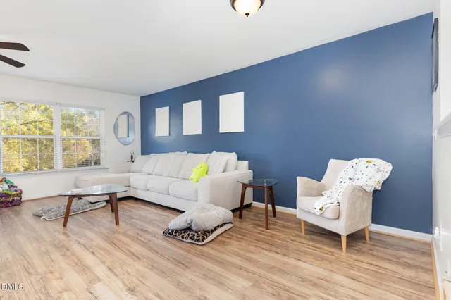 a living room with furniture and wooden floor
