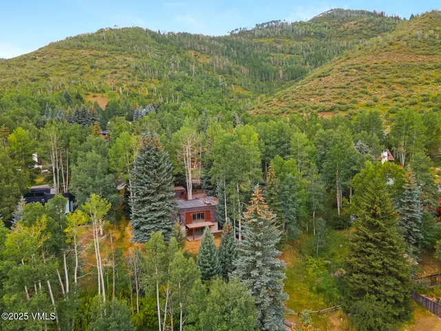 a kitchen with granite countertop a sink and a wooden cabinets
