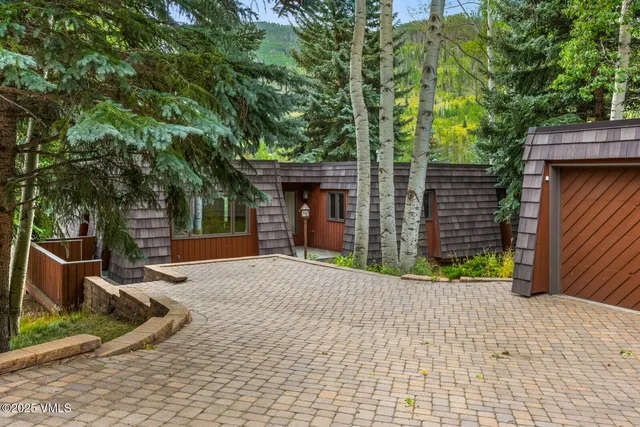 a view of a house with a yard and tree s