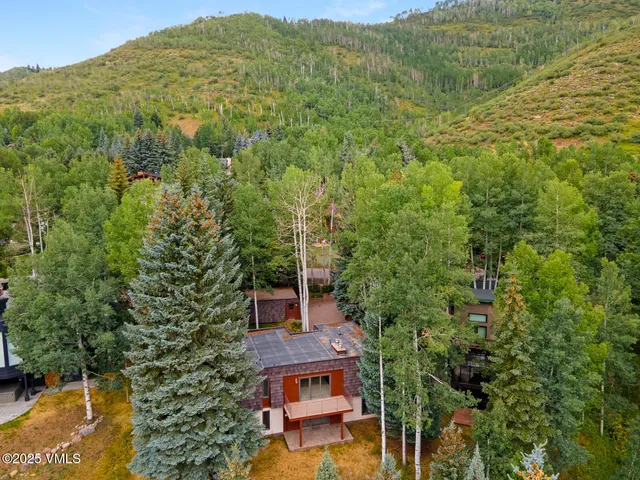an aerial view of a house with a yard