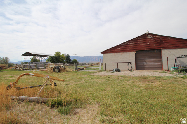420 South 1400 West Logan, UT 84321 - Photo 1 of 5 View of yard featuring a detached garage, an outbuilding, and a rural view