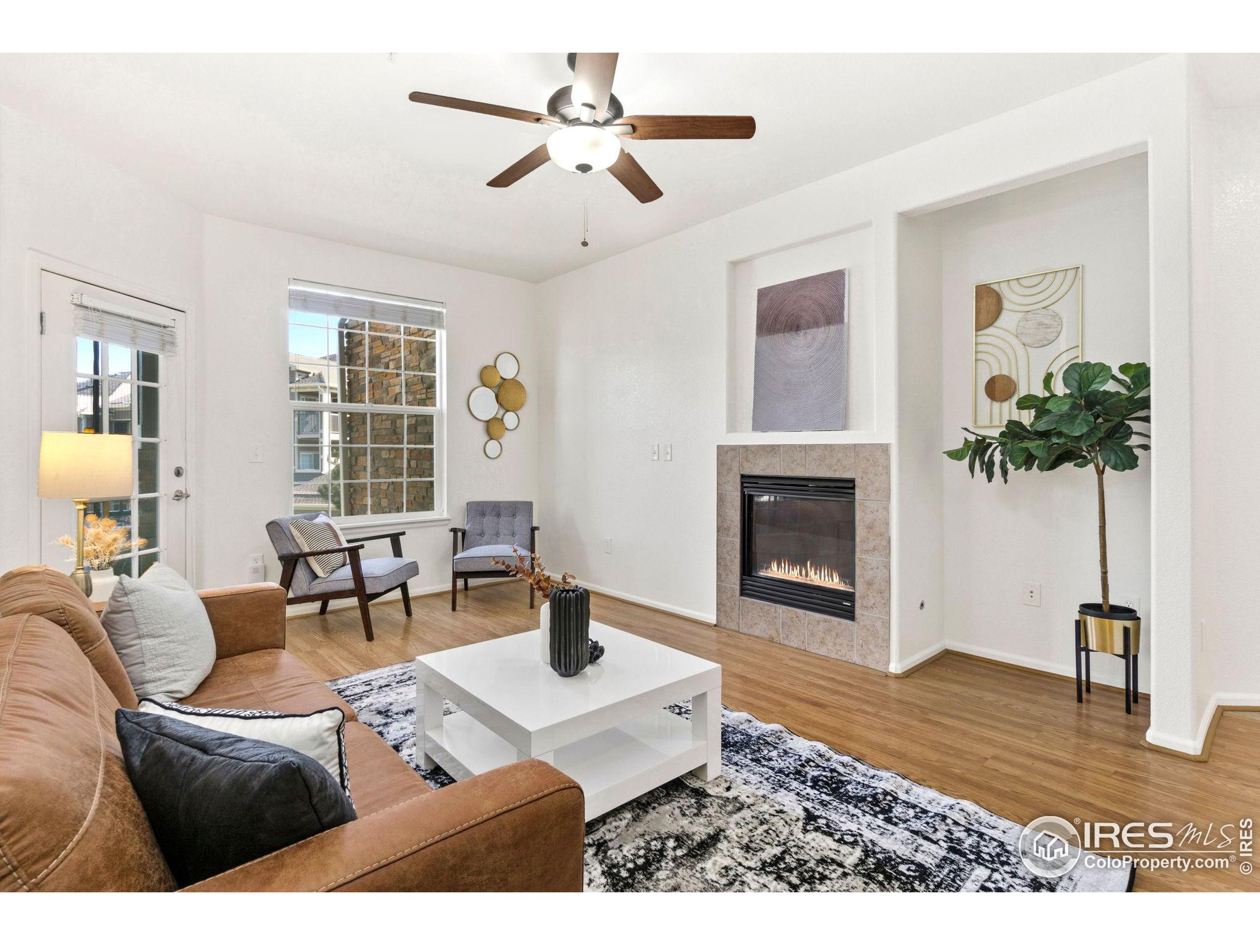 a living room with furniture a chandelier and a fireplace
