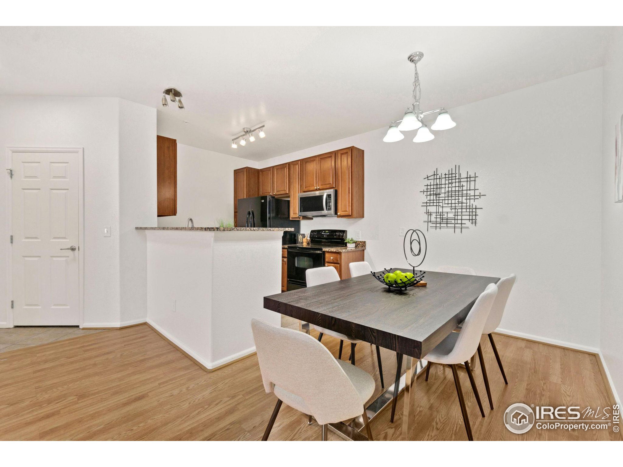 Undisclosed Address Erie, CO 80516 - Photo 3 of 20 a view of kitchen and dining area with a table chairs
