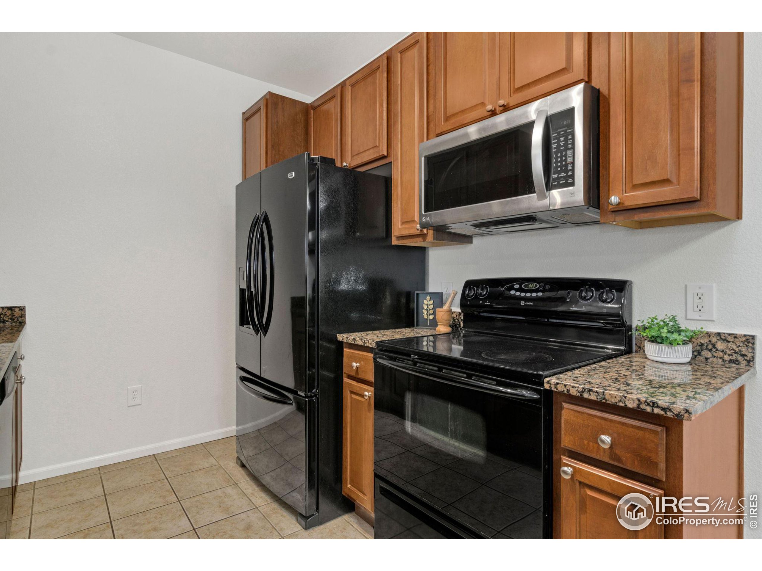 Undisclosed Address Erie, CO 80516 - Photo 4 of 20 a kitchen with stainless steel appliances granite countertop a stove microwave refrigerator and sink