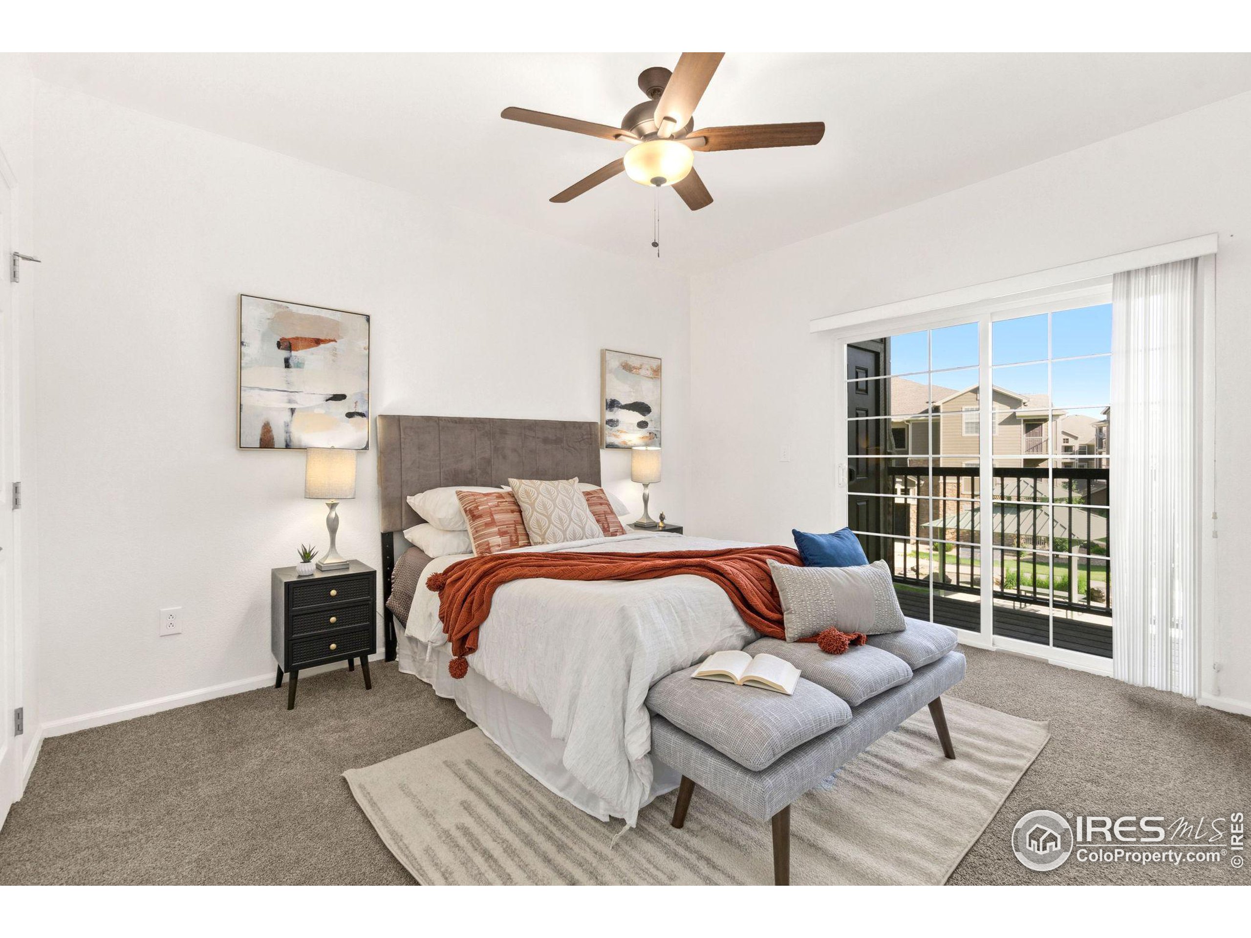 Undisclosed Address Erie, CO 80516 - Photo 6 of 20 a bedroom with a bed a couch and a chandelier